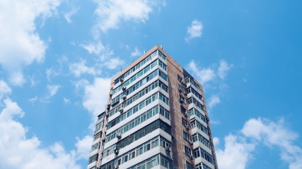 Aşağıdan yukarı doğru görünen çok katlı apartman bloğu