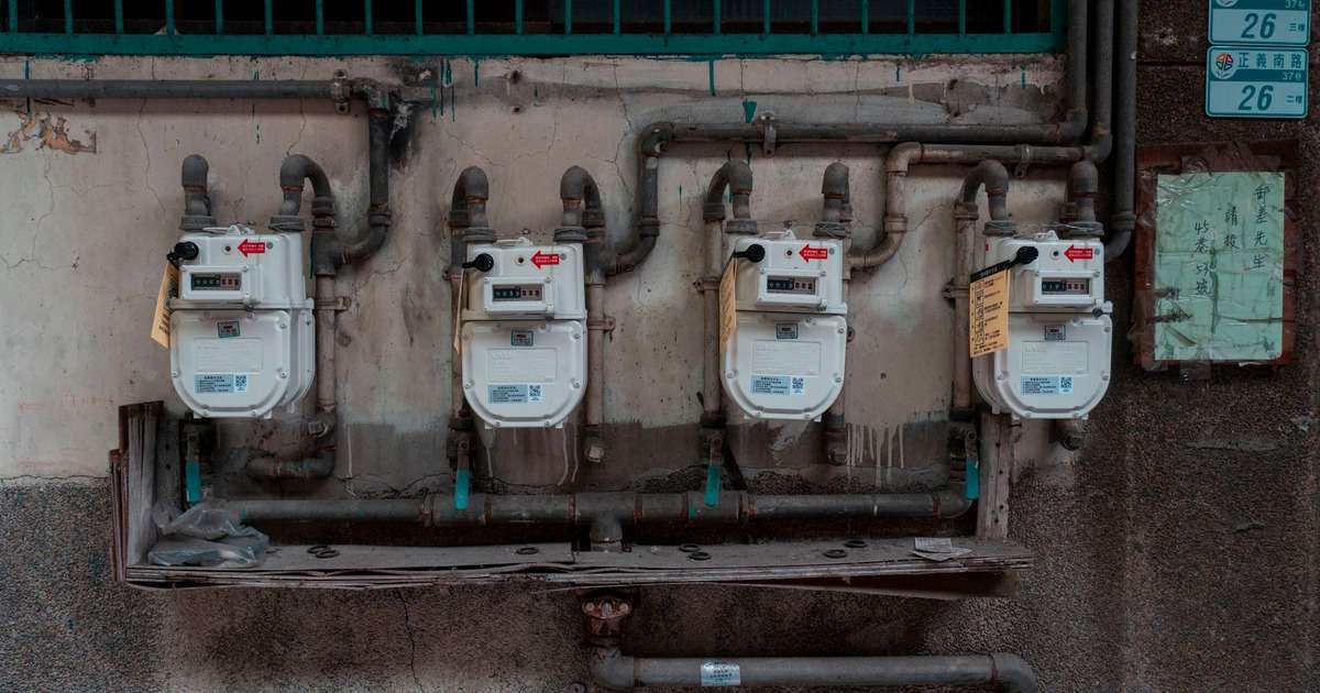 Bina duvarında yan yana sıralanmış dört gaz sayacı ve bağlantı boruları